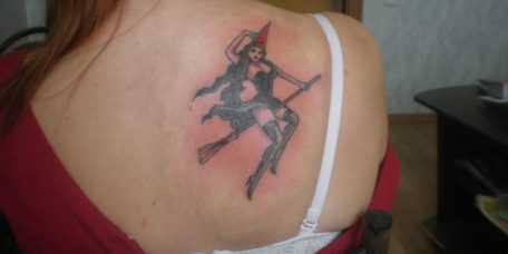 Тату у девушки на лопатке, ведьма на метле