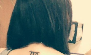 Татуировка на спине - знак зодиака